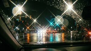 מבט מתוך רכב בלילה המדגים כיצד אדם עם אסטיגמציה (צילינדר) רואה הילות ומריחות אור סביב פנסי רחוב.